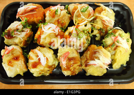 Japanese Dumplings in black plate on wood table Stock Photo