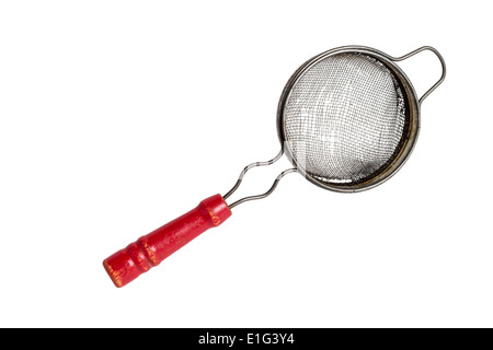 Antique tea strainer with a red wooden handle on a solid white background Stock Photo