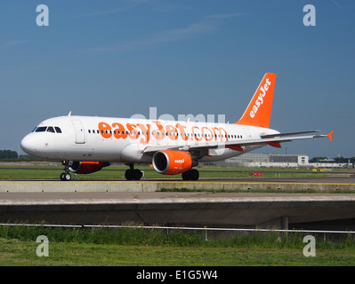 The easyJet Airbus A320-214, registration G-EZTH, taxis at Schiphol Airport (AMS - EHAM) in the Netherlands. The aircraft is part of easyJet's regional fleet, identified by its specific construction number (cn 3953). Stock Photo