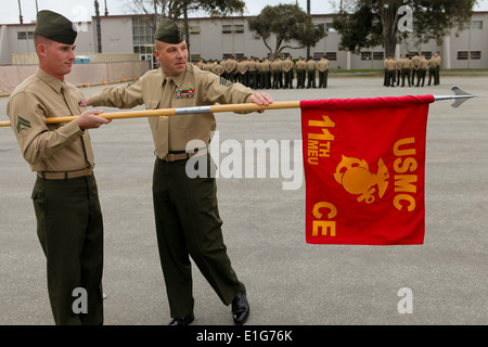 Gunnery Sergeant Robert Lytle with the 11th Marine Expeditionary Unit (right), teaches close order drill movements to Cpl. Mich Stock Photo