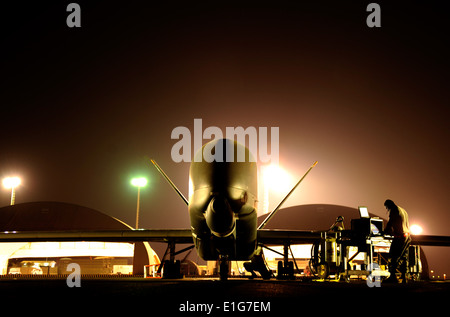 U.S. Air Force maintenance technicians conduct preflight checks on an RQ-4 Global Hawk unmanned aerial vehicle assigned to the Stock Photo