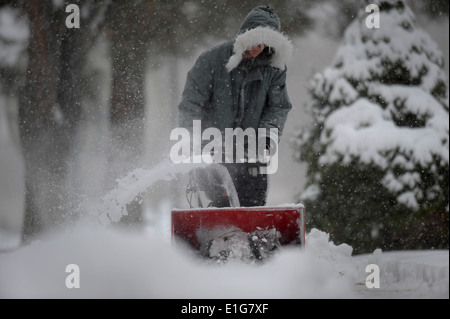 U.S. Airman 1st Class air traffic controller Peter Logar with 366th Operations Support Squadron removes snow from sidewalks aro Stock Photo