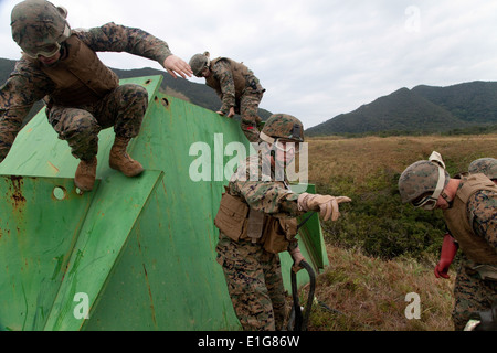 U.S. Marine Corps Staff Sgt. Matthew Nissel, second from right, platoon commander of 1st Platoon, Landing Support Company, Comb Stock Photo