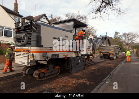 view of a Wirtgen W 2100 Cold Milling Machine at work, removing  the road surface in a suburban street in Lewisham. Stock Photo