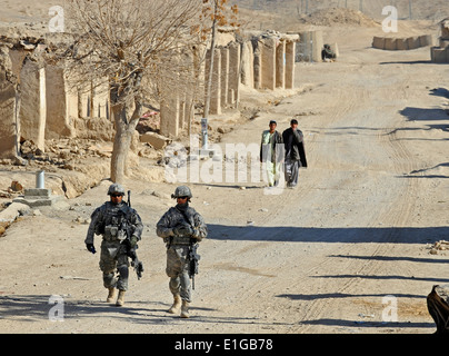 U.S. Army Sgt. Johnny Hoyos, left, and Air Force Senior Airman Aaron Royston patrol a road during a shura in the Mizan district Stock Photo