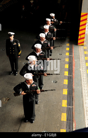 U.S. Sailors with an honor detail conduct a rifle volley during a memorial service aboard the aircraft carrier USS Enterprise ( Stock Photo