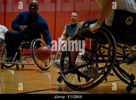 Willie Jackson, left, the coach of the San Antonio Para Sport Spurs team, dribbles the ball up court during a scrimmage game wi Stock Photo