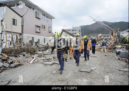 Fire and rescue personnel with the Fairfax County Urban Fire and Rescue team head into downtown Ofunato, Japan, March 15, 2011, Stock Photo