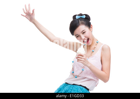 Excited young woman with ice cream cone singing Stock Photo