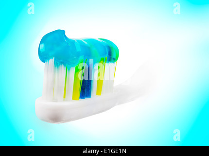 Tooth brush with paste on blue and white background. Stock Photo