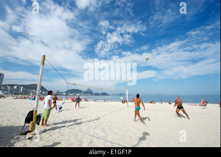 RIO DE JANEIRO, BRAZIL - CIRCA JANUARY, 2011: Young Brazilian men play a game of footvolley, a sport that combines football and Stock Photo