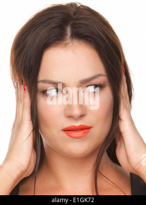 Pretty girl with red lipstick, ears covered with hands, three wise monkeys series. Stock Photo