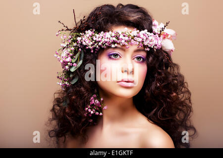 Luxuriant. Femininity. Fashion Model with Classic Wreath of Flowers Stock Photo