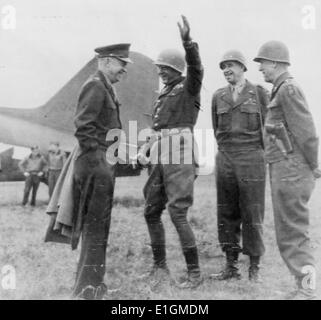 Photograph shows General Eisenhower meeting with generals Patton, Bradley, and Hodges on an airfield somewhere in Germany. Dated 1945 Stock Photo