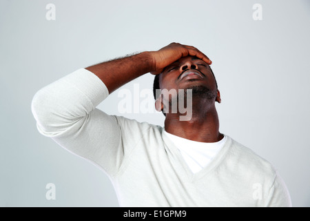 Portrait of a tired african man on gray background Stock Photo