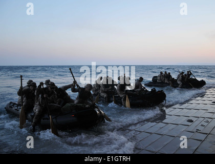 U.S. Marines assigned to the 22nd Marine Expeditionary Unit launch a combat rubber raiding craft from the well deck of the mult Stock Photo