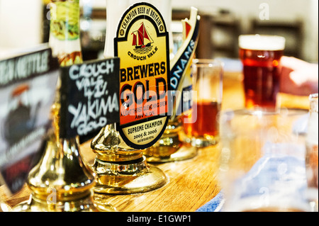Real Ale beer pump handles on a bar. Stock Photo