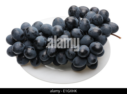 Bunch of black grapes on a white plate, isolated Stock Photo