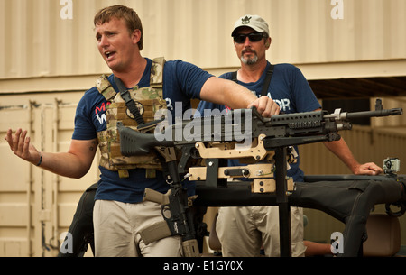 U.S. Marine Corps Sgt. Dakota Meyer, left, prepares to demonstrate an M240 machine gun for competitors during the Maximum Warri Stock Photo