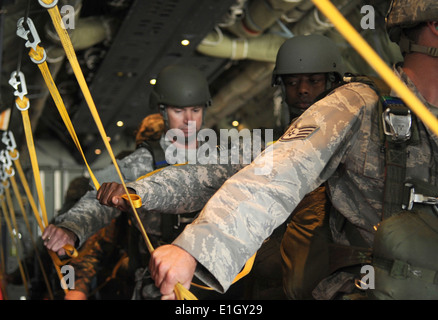 U.S. Soldiers and Airmen and allied paratroopers prepare to conduct a static line jump from an Air Force C-130J Super Hercules Stock Photo