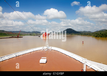 Cruise ship transits across Gatun lake on a beautiful day with cargo ships & Pedro Miguel lock ahead, Panama Canal, Panama. Stock Photo