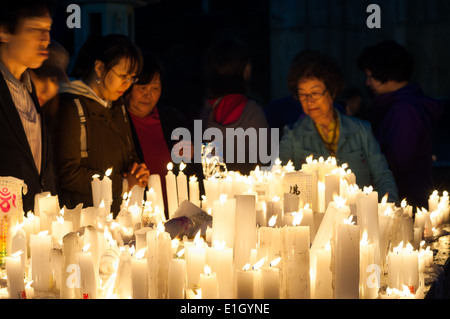 Buddhists light candles and pray during Buddha's birthday at Bongeunsa Temple on May 6, 2014 in Seoul, South Korea. Stock Photo