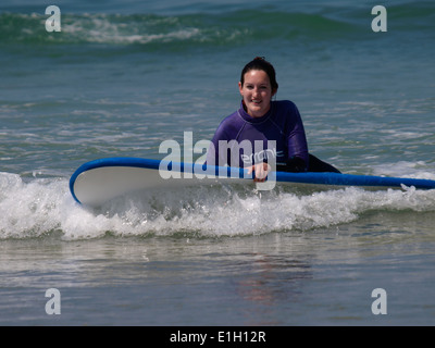 Young woman learning to surf, Newquay, Cornwall, UK Stock Photo