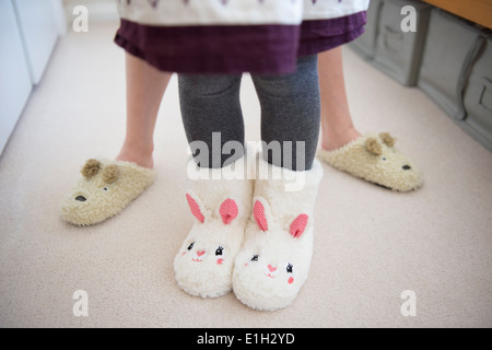 Children wearing animal slippers Stock Photo