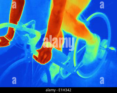 Close up thermal image of young male athlete in training, showing the heat of the muscles and of the bicycle tires Stock Photo