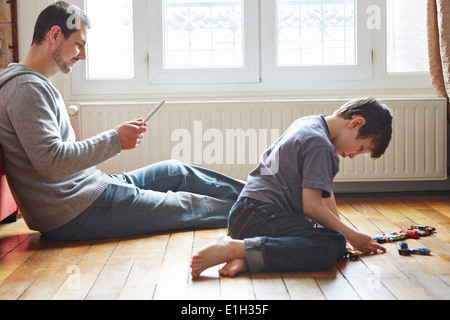 Father and son spending time in living room Stock Photo