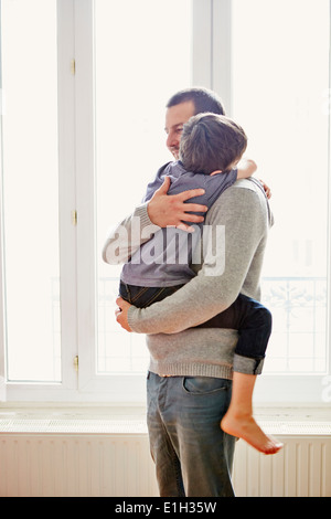 Boy showing affection to father Stock Photo