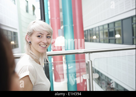 Young woman with blonde hair smiling, portrait Stock Photo
