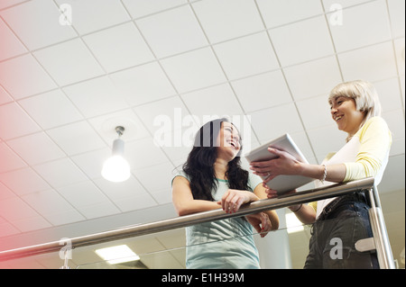 Young women with digital tablet, low angle Stock Photo