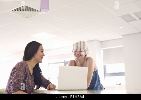 Two young women using laptop Stock Photo