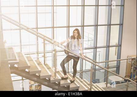 Young women standing on staircase Stock Photo