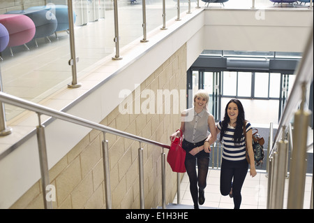 Young women walking up staircase Stock Photo