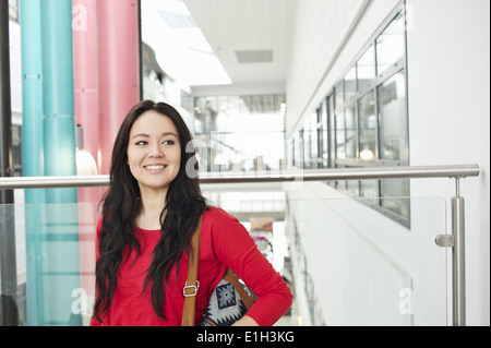 Young woman with long black hair smiling, portrait Stock Photo