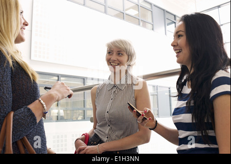 Young women using cell phones Stock Photo