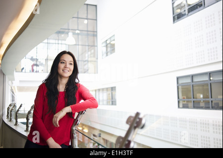 Young woman leaning on railing, portrait Stock Photo
