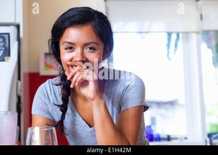Young woman in kitchen Stock Photo