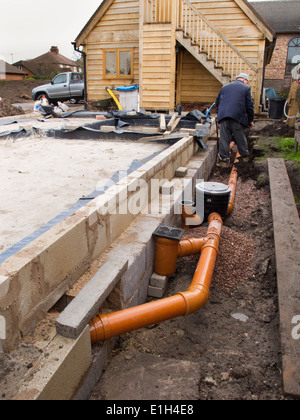 self building house, drainage, man making drain pipe connection to gullies Stock Photo