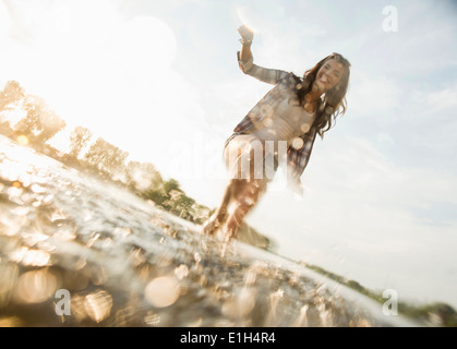 Young woman paddling in lake Stock Photo