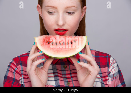 Young woman with slice of watermelon