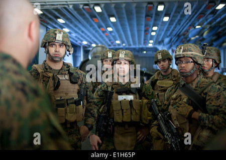 U.S. Marines with India Company, Battalion Landing Team, 3rd Battalion, 1st Marine Regiment, listen to directions from company Stock Photo