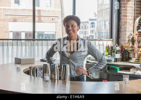 Portrait of waitress behind restaurant bar Stock Photo