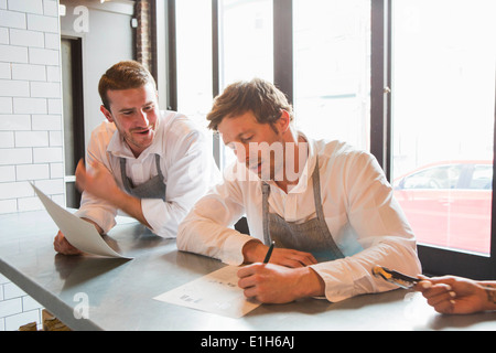 Chefs preparing for service in restaurant Stock Photo