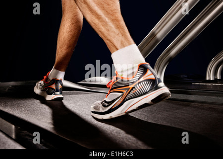 Close up of male legs running on gym treadmill in altitude centre Stock Photo