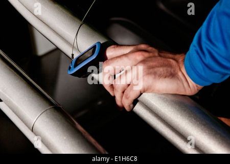 Close up of male hand and heart rate monitor on gym treadmill in altitude centre Stock Photo