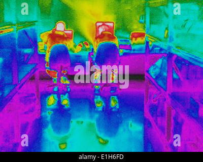 Infra red heat image of workers and heat loss at computer work station