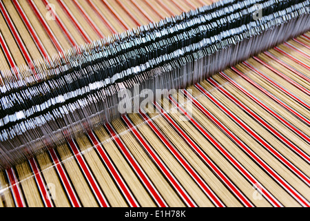 Close up of striped textile on weaving machine in woollen mill Stock Photo